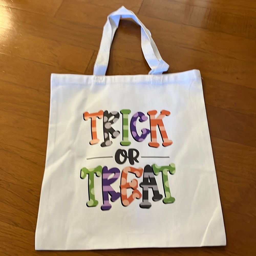 White tote bag with “Trick or Treat” in Halloween colors
